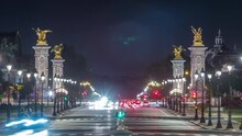 View Of Avenue Du Marechal Gallieni With Traffic And Night Illumination Timelapse. Avenue Du Marechal Gallieni Connects Les Invalides (National Residence Of Invalids) Complex And Alexandre III Bridge