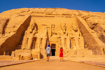 A couple of European tourists visit the Abu Simbel Temple in southern Egypt in Nubia next to Lake Nasser. Temple of Pharaoh Ramses II, travel lifestyle