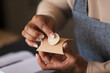 © Martin Barraud/Caia Image - Close up female shop owner placing handmade label on box