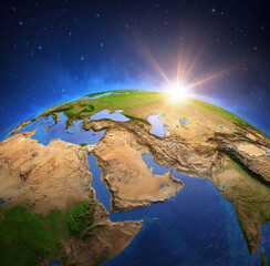 Wall Mural - surface of planet earth viewed from a satellite, focused on middle east, sun rising on the horizon. 