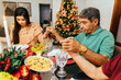 © kleberpicui - Brazilian Christmas. Family praying before Christmas dinner.