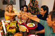© kleberpicui - Christmas in Brazil. Family toasting at Christmas dinner.