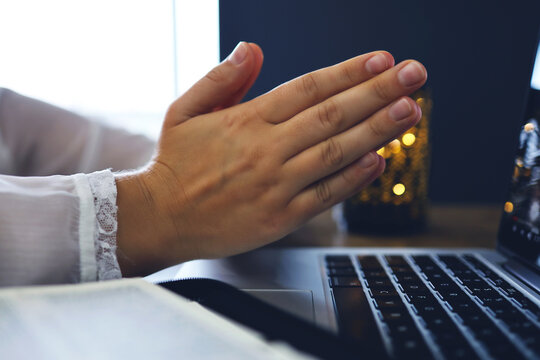 Woman praying by faith with computer laptop, Church services online concept, Online church at home concept