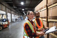 Staff Working On Inventory Tracking In Distribution Warehouse