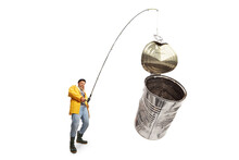 Fisherman Catching Tin Can On A Fishing Rod