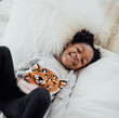 © Sween Shots/Stocksy - Little Girl Jumping in the bed and laughing