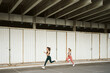© Javier D√≠ez/Stocksy - Young athletes running on street