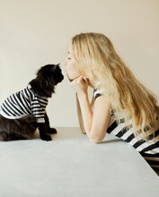 Blond Girl And Black Cat In Identical Striped T-shirts