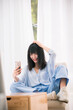 © Makingultimate Xiao/Stocksy - A Chinese beauty is using her mobile phone
