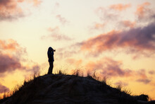 Photographer Silhouette On Sunset Sky Background