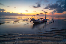 Landscape With A Fishing Boat In The Ocean At Low Tide At Dawn