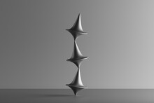 Three Dimensional Render Of Three Metallic Spinning Tops Balancing On Top Of Each Other