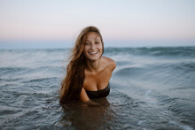 Smiling Young Woman Enjoying In Sea At Beach