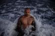 © Gala Martínez López/Westend61 - Shirtless handsome mid adult man standing amidst waves in sea
