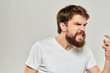 © SHOTPRIME STUDIO - man in white t-shirt emotions expressions gesture with hands cropped view light background