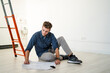 © Giorgio Fochesato/Westend61 - Architect sitting on floor while reading blueprint at office