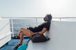 © Eugenio Marongiu/Westend61 - Woman wearing face mask resting while sitting in passenger craft