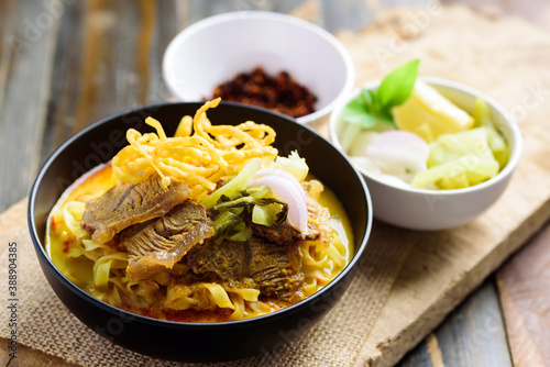 Fotomural Northern Thai food (Khao Soi), Spicy curry noodles soup with beef in a bowl eati