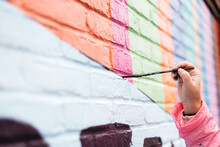 Artist Painting A Wall With A Brush