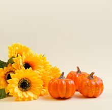 Bouquet Of Sunflowers And Pumpkin On A Beige Background