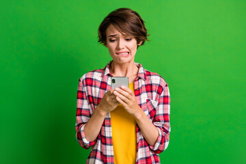 Sticker - Photo of worried person bite lip look screen oops mistake plaid clothing isolated on green color background