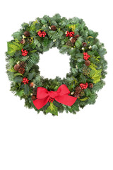 Christmas spruce fir wreath with winter berry holly, mistletoe, acorns, pine cones & greenery on white background. Traditional composition for the festive season. Copy space.