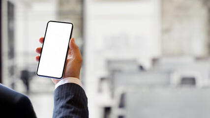 Male hand using smartphone in blurred background