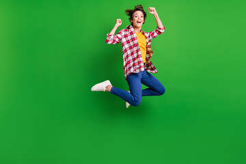 Poster - Full size profile photo of impressed sweet girl jumping hands fists wear trousers shirt sneakers isolated on green color background