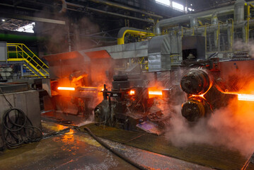 hot steel on conveyor in a steel mill. hot rolled rebar