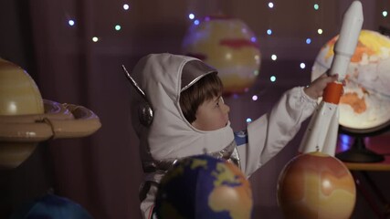 Wall Mural - Space Travel Spaceship. Creative Little Kid Boy Astronaut Launching Rocket From Spaceport Through Planets. Child Dreamer Playing Toy Space Rocket Flying Among Planets. Spaceman Fantasy Flying on Space