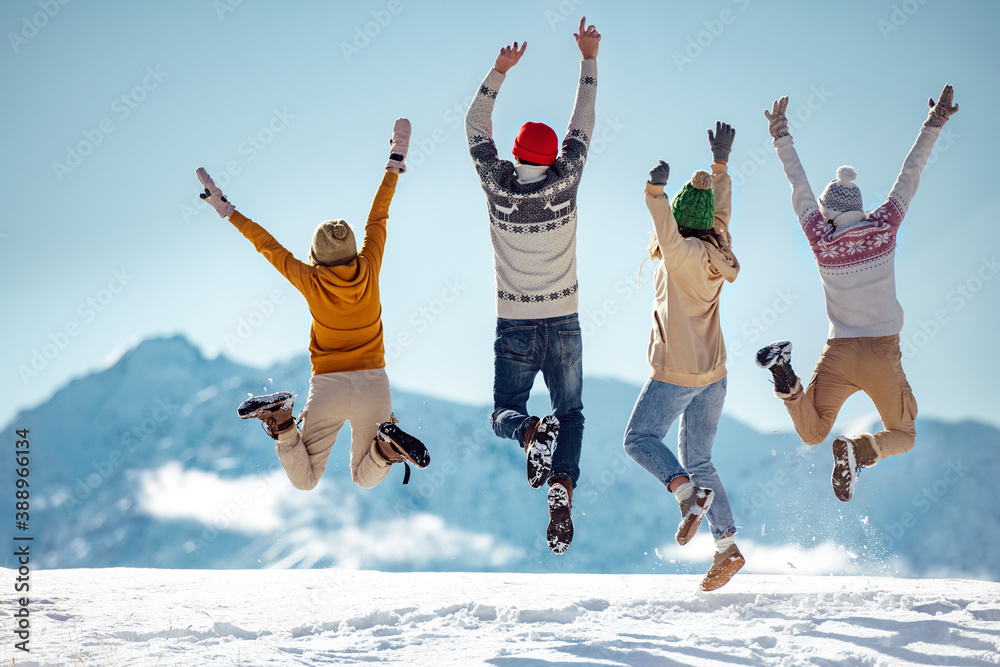 Friends celebrates beginning of winter in mountains - obrazy, fototapety, plakaty 