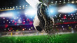 © alphaspirit - Football scene at night match with close up of a soccer shoe hitting the ball with power