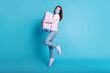 © deagreez - Full size photo of girl jump hug suitcase wear blue fabric face mask isolated over blue color background