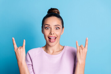 Sticker - Photo of crazy hipster girl show horns symbol tongue out enjoy rejoice punk concert wear lilac pullover isolated over blue color background