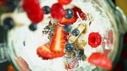 Wall Mural - Fresh berries smoothie blended in blender, top view. Healthy eating concept. Super slow motion filmed on high speed cinematic camera.