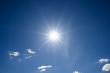 Wall Mural - sun on blue sky with white clouds.