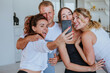 © lithiumphoto - Smiling young people having fun making selfie photo