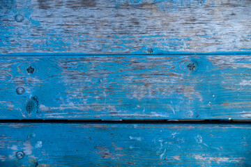 Vintage wood texture. Cracked blue paint on a wooden background.