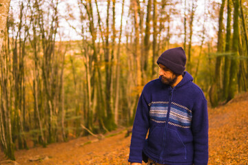 Wall Mural - Lifestyle, a young man in a blue wool sweater enjoying the forest in autumn. Artikutza Forest in San Sebastián, Gipuzkoa, Basque Country. Spain