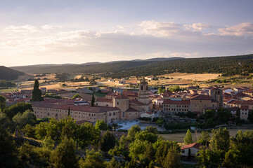 City landscape of Santo Domingo de Silos from a rock on the top of the hill and the Monastery of Silos in the city center at sunset, Burgos, Spain