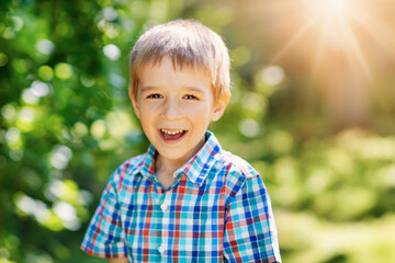 Wall Mural - Happy child smiling outdoors on sunny day