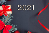 Fototapeta  - new year decorations with inscription 2021 from wooden numbers on dark background