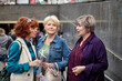 © grigvovan - Middle-aged pretty females are standing near underpass and talking.