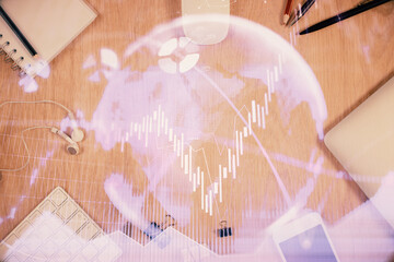 Multi exposure of forex graph hologram over desktop with phone. Top view. Mobile trade platform concept.