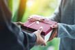 © Farknot Architect - Closeup image of a man giving a woman a gift box
