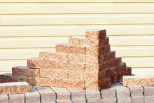 Neat Carved Blocks Of Red Granite Are Stacked.