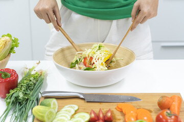 Wall Mural - Eat healthy food for good wellness health concept. Woman cooking salad menu with fresh organic vegetables