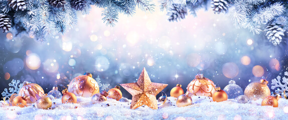 Wall Mural - abstract christmas card - golden ornament on snow with fir branches and defocused lights