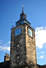 Wall Mural - Old Stone Tower with Clock & Cupola seen from  below against Blue Sky 