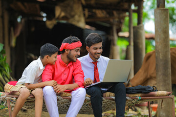 Wall Mural - Young indian farmer and agronomist or banker discuss at home